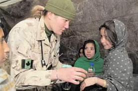 Corporal Julie Alain, medic, examining an Afghan girl at a free medical clinic run by Afghan, Canadian and US medical and dental personnel in Spin Boldak, Afghanistan.
