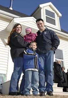 Leading Seaman Michael Fraser and his family gathered outside their new home